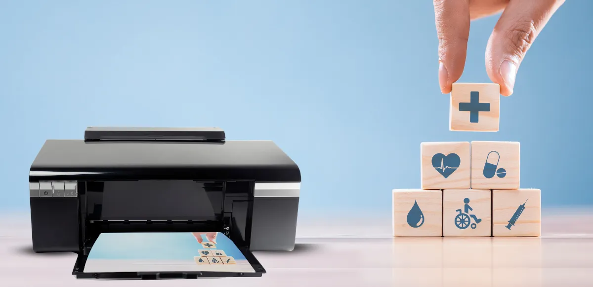 Inkjet printer printing a photo beside wooden blocks with healthcare icons