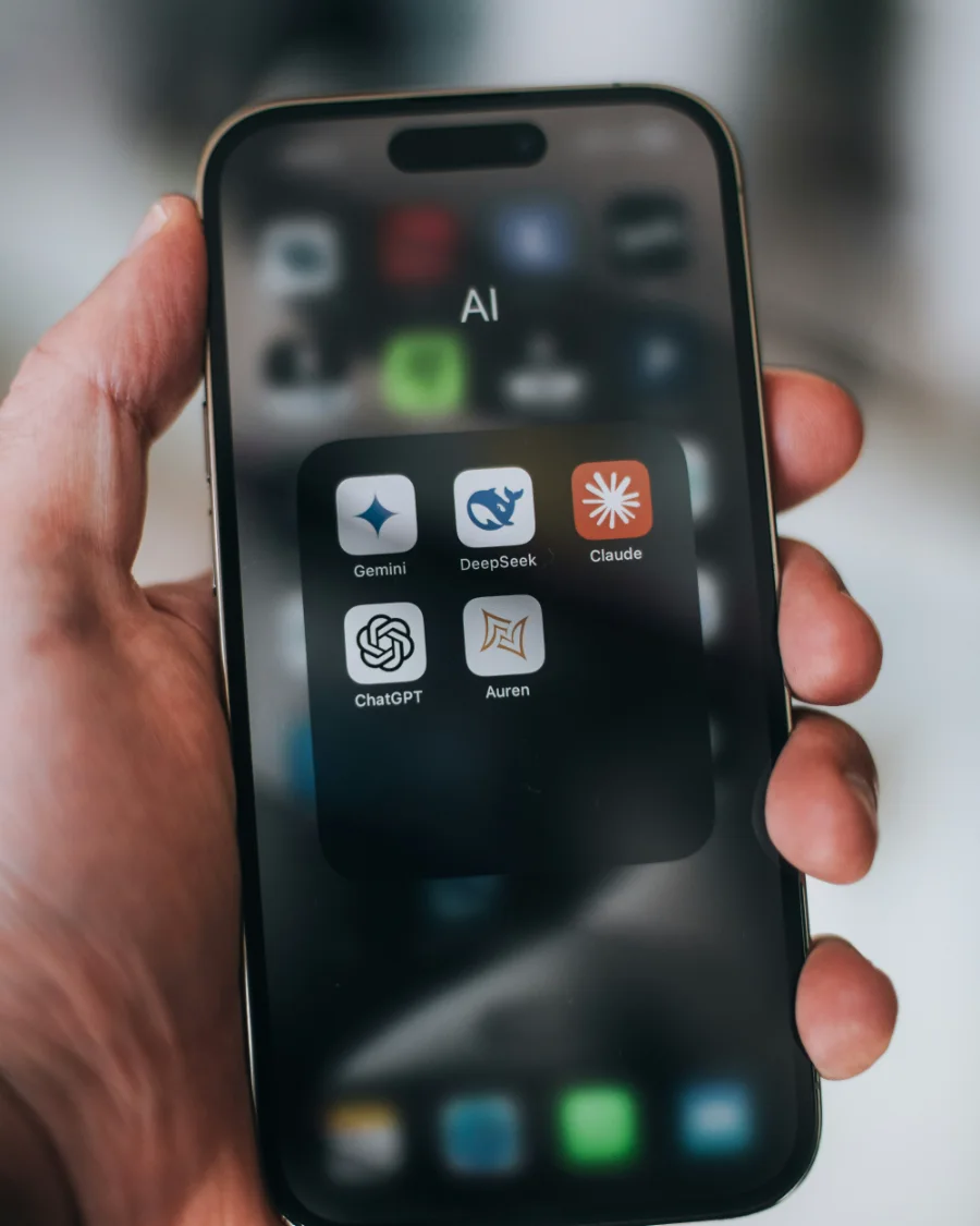 Phone showing AI assistant apps including ChatGPT, Gemini and Claude