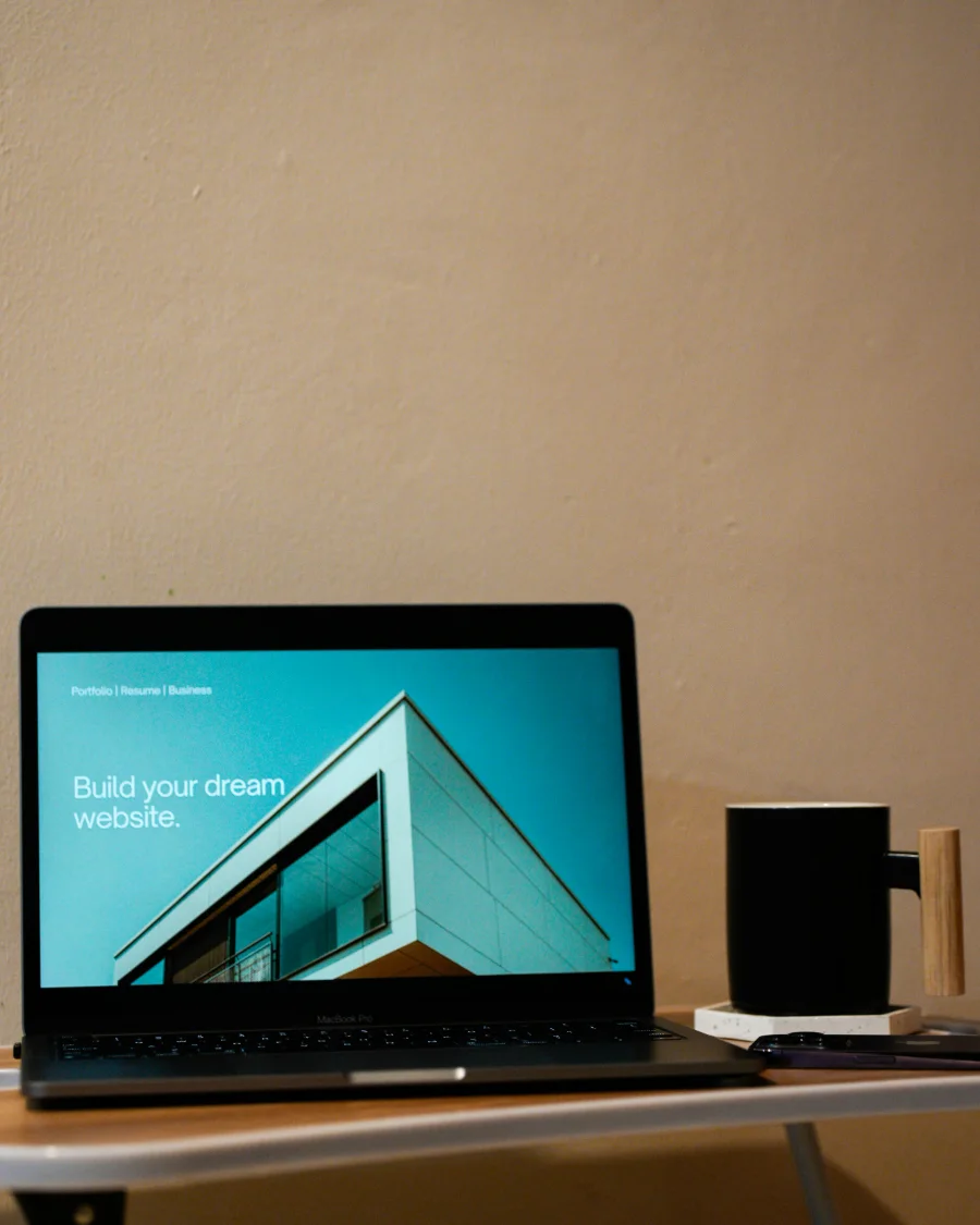 Laptop showing a corporate website homepage on a desk